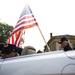 Mike Van Wasshnova stands with an American Flag beside the Sons of Union Veterans of the Civil War Camp #180  vehicle on Monday, May 27. Daniel Brenner I AnnArbor.com